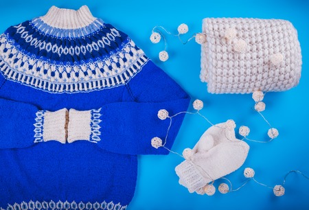 Winter female outfit. Set of clothes and accessories on blue backgroundの写真素材