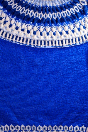 Ornament of a blue and white icelandic sweater. Knitted winter clothes.の写真素材
