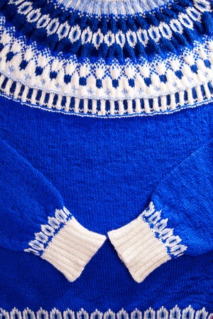 Ornament of a blue and white icelandic sweater. Knitted winter clothes.の写真素材
