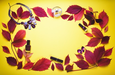 Set of cosmetics and accessories on yellow autumn backgroundの写真素材