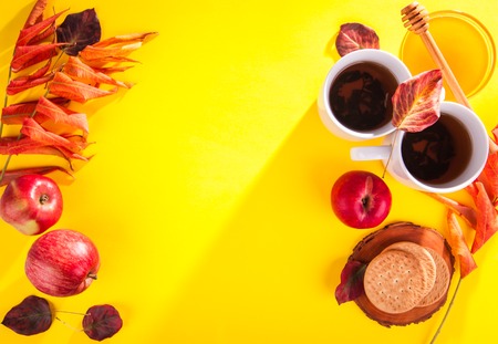 Hot tea with apples and honey on a wooden tray. Autumn harvestの写真素材