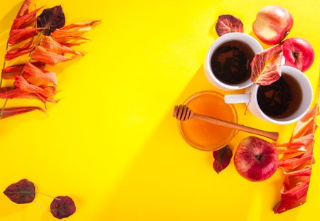 Hot tea with apples and honey on a wooden tray. Autumn harvestの写真素材