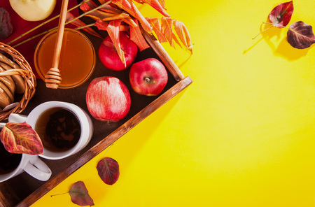Hot tea with apples and honey on a wooden tray. Autumn harvestの写真素材