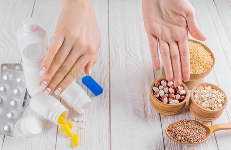 Pills or healthy eating choice. Healthy diet concept. Set of pills and cereals.の写真素材