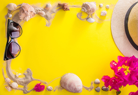 Vacation concept. Sand, seashells, sunglasses and hat with flowers. Spaceの写真素材