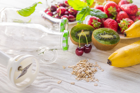 Cooking fruity smoothie on wooden table. Healthy eating. Organic foodの写真素材