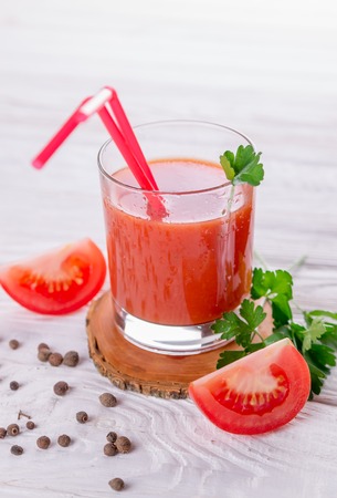 Tomato juice in glasses on white wooden background. Bloody Maryの写真素材