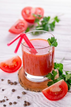 Tomato juice in glasses on white wooden background. Bloody Maryの写真素材