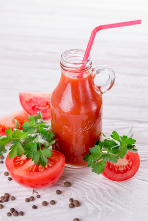 Tomato juice in glasses on white wooden background. Bloody Maryの写真素材