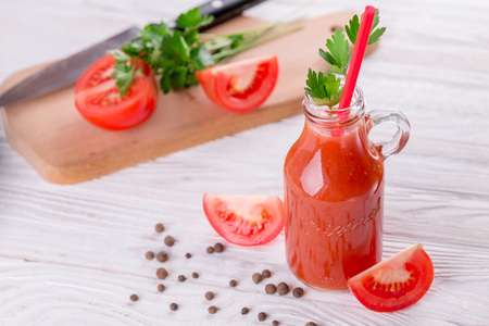 Tomato juice in glasses on white wooden background. Bloody Maryの写真素材