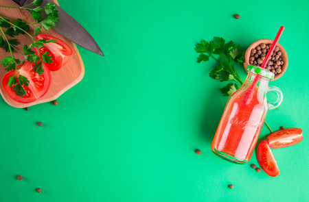 Tomato juice in the bottle on green background. Healthy drinkの写真素材