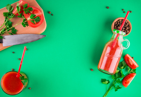 Tomato juice in the bottle on green background. Healthy drinkの写真素材