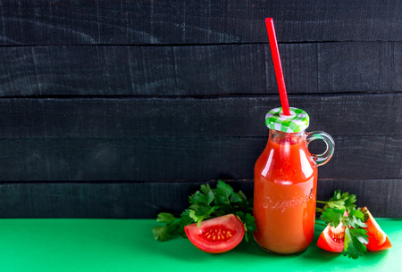 Tomato juice on black wooden background. Healthy drink. Spaceの写真素材
