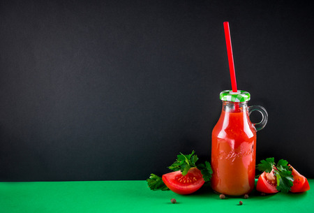 Tomato juice on black wooden background. Healthy drink. Spaceの写真素材