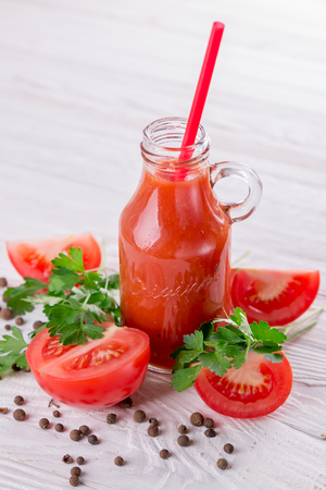 Tomato juice in glasses on white wooden background. Bloody Maryの写真素材