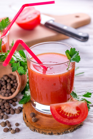 Tomato juice in glasses on white wooden background. Bloody Maryの写真素材