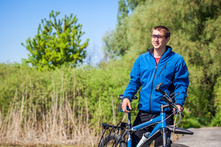 Young bicyclist rides a mountain bike in the forestの写真素材