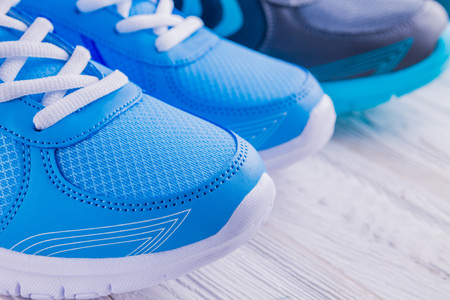 Two pairs of sneakers on wooden backgroundの写真素材