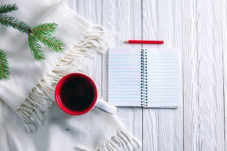 Christmas background with a cup of tea and scarfの写真素材