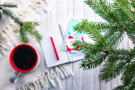 Christmas background with a cup of tea and scarfの写真素材