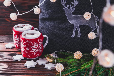 Hot chocolate with marshmallows and biscuits on Christmas decorations background.の写真素材