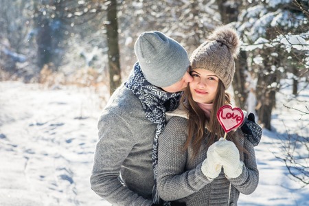 Portrait of young couple in love holding lollipopの写真素材
