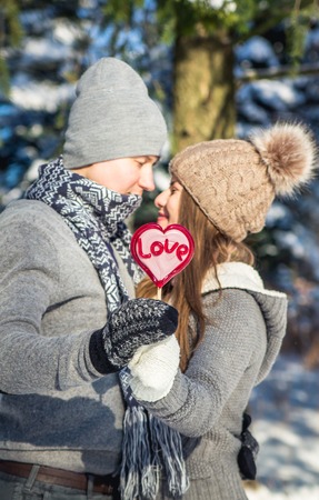 Portrait of young couple in love holding lollipopの写真素材