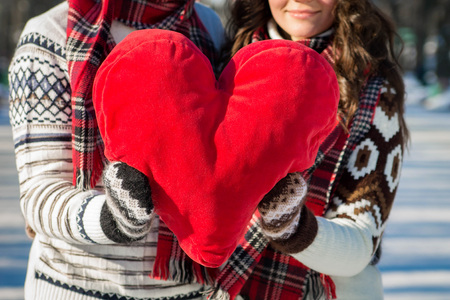 Couple in love holds red pillow heart. Valentine's day conceptの写真素材