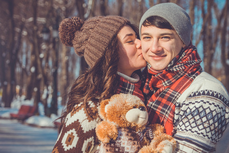 Portrait of young couple in love holding teddy bearの写真素材