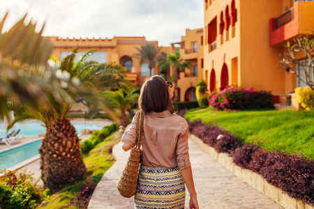 Portrait of young stylish woman walking on hotel territory in Egypt. Traveling conceptの写真素材
