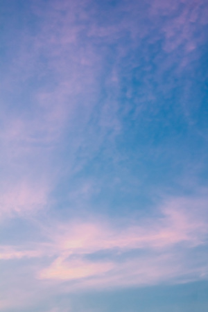 Pink cloudy sky background at sunset. Natural texture