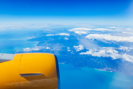 Plane window view of Egypt surrounded by sea, blue sky and airplaneの写真素材