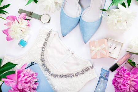 Summer female outfit. Set of clothes, shoes, cosmetics and accessories with peonies flowers. Beauty fashion concept. Trendy jewellery.の写真素材