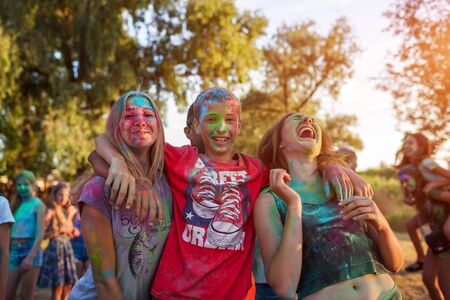Myrhorod, Ukraine - June 16, 2019: Group of a young friends throwing paints on indian Holi festival of colorsのeditorial素材