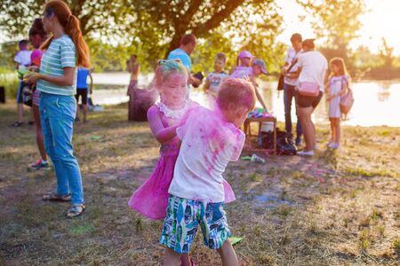 Myrhorod, Ukraine - June 16, 2019: Two kids throwing paints on indian Holi festival of colorsのeditorial素材