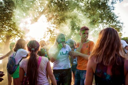 Myrhorod, Ukraine - June 16, 2019: Group of a young people throwing paints on indian Holi festival...