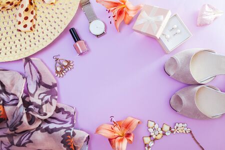 Summer female outfit. Set of clothes, shoes, cosmetics and accessories with fresh flowers. Beauty fashion concept. Trendy jewellery. Copy spaceの写真素材
