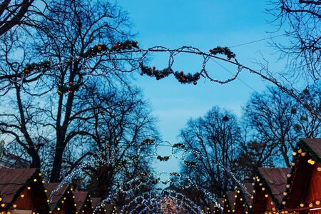 Lviv Christmas fair 2019. New year decorations hung outdoors. Illuminated stores and trees. Holiday seasonの写真素材