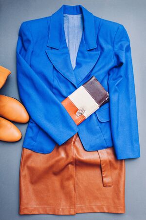Classic blue trendy color of 2020. Spring female clothes outfit. Stylish blue jacket, brown shoes boots, purse for women. Beauty fashionの写真素材