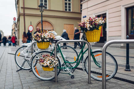 Bicycles decorated with flowers in baskets on street in Krakow, Poland. Trip to Europeの写真素材