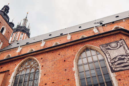Sundial on wall of Virgin Mary Basilica in Krakow, Poland. Krakow landmarks and ancient architecture. Historical tourist attractionsの写真素材
