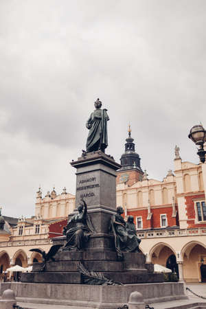 Adam Mickiewicz statue on market square in Krakow, Poland. Famous places of interest and ancient...