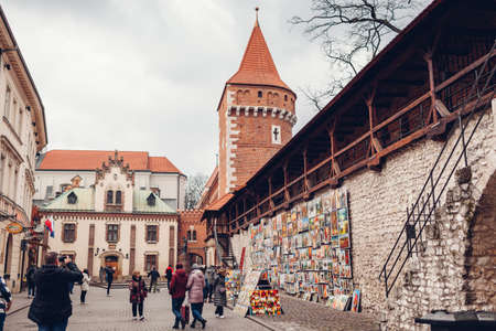Krakow, Poland - March 8, 2020: st. Florian's Gate, Brama Florianska with tower and tourists walking by paintingsのeditorial素材