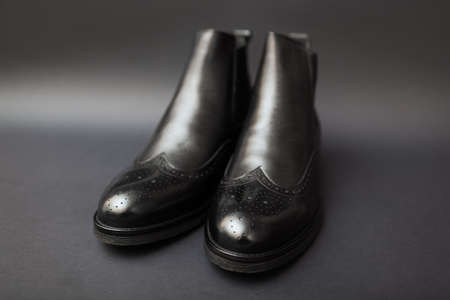 Shoes, chelsea leather boots for men. Male winter, autumn or spring fashion. Footwear on black background. Saleの写真素材