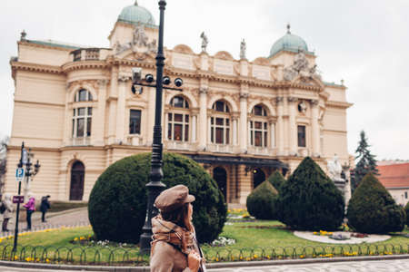 Tourist admiring Krakow Slowackiego theater exterior in Poland. Architecture, landmarks of Krakow...