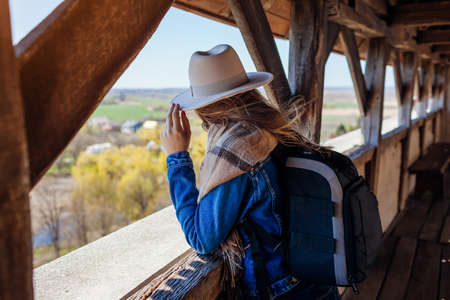 Tourist woman walking on Olesko Castle balcony admiring spring landscape view. Travelling in Western Ukraine.の写真素材