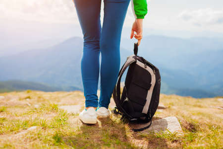 Hiking in Carpathian mountains. Hiker woman carrying backpack enjoying landscape. Close up of legs. Traveling in summer Ukraineの写真素材