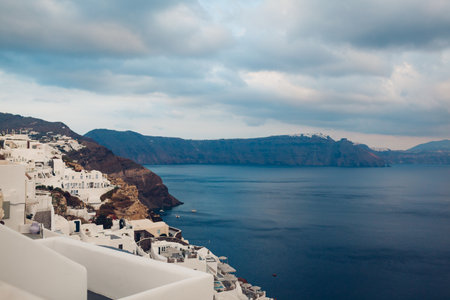 Santorini island Oia landscape. Traditional white houses on cliff with sea and mountains view. Local architecture. Travel to Greece.の写真素材