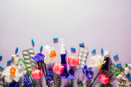 Seasonal spring allergy mockup. Pills and nasal spray flat lay with purple flowers. Medicine for allergic people. Spaceの写真素材