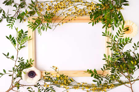 Beautiful spring, summer composition. Blank frame for text, flowers, leaves on white background.. Flat lay, top view, copy space.の写真素材